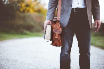 man carrying leather bag